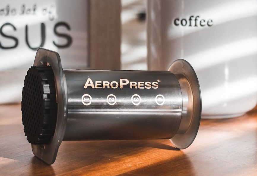 black coffee press on wooden table